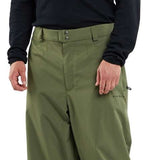 Volcom X Dustbox Pant 2024 - A pair of olive green snow pants with a subtle pattern and zippered pockets.