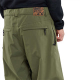 Volcom X Dustbox Pant 2024 - Olive green pants with a zippered pocket on the right thigh and a small logo patch near the bottom of the left leg.