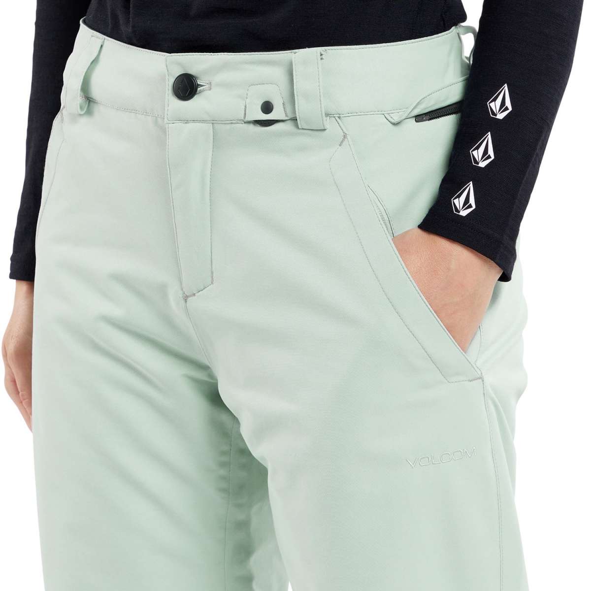 Volcom Women's Frochickie Insulated Pant 2024 - A pair of light green snowboard pants with a black zipper on the back pocket.