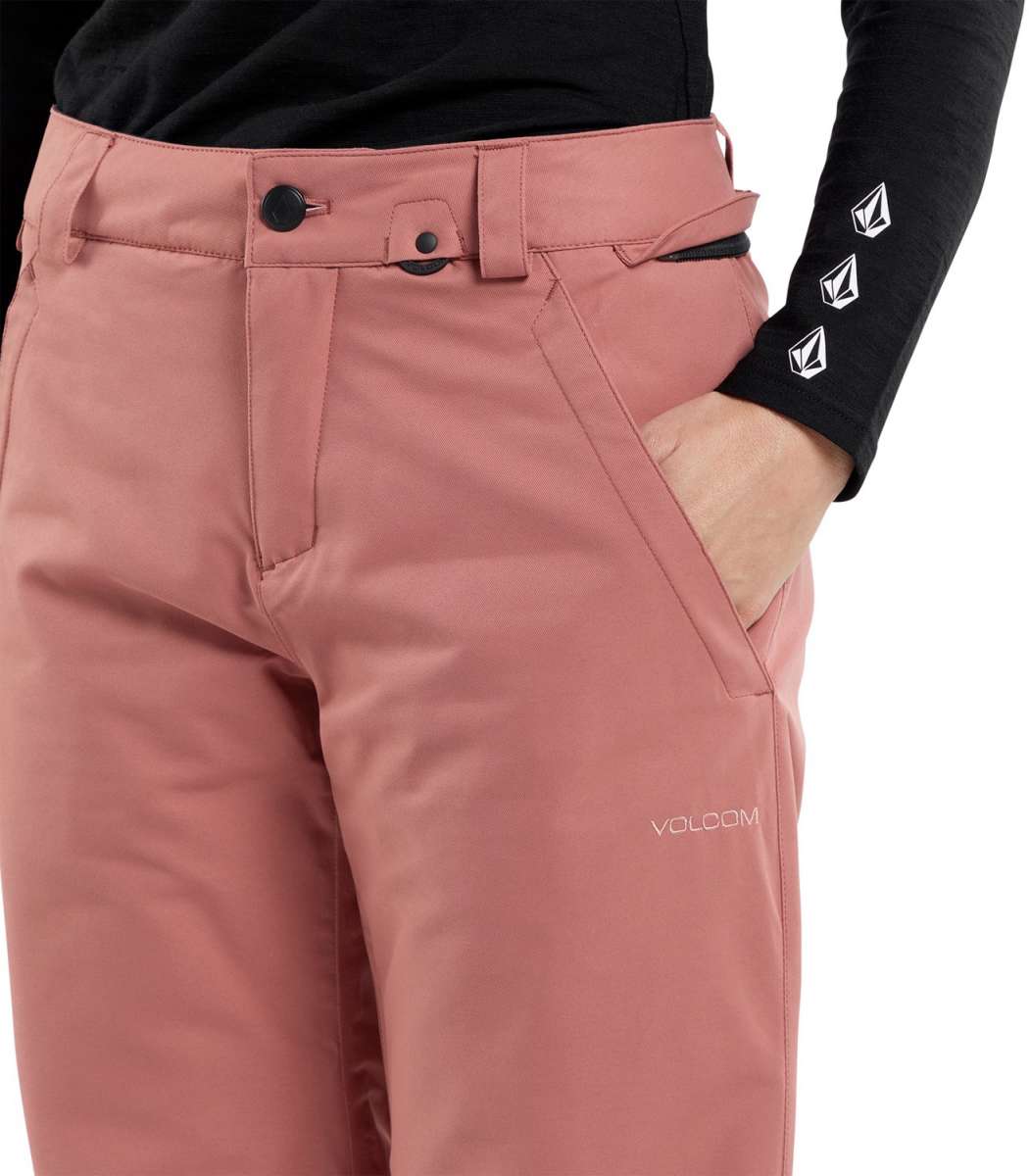 Volcom Women's Frochickie Insulated Pant 2024 - A dusty rose-colored pair of insulated ski pants with a black button on the waistband and a white logo on the left thigh.