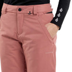 Volcom Women's Frochickie Insulated Pant 2024 - A dusty rose-colored pair of insulated ski pants with a black button on the waistband and a white logo on the left thigh.
