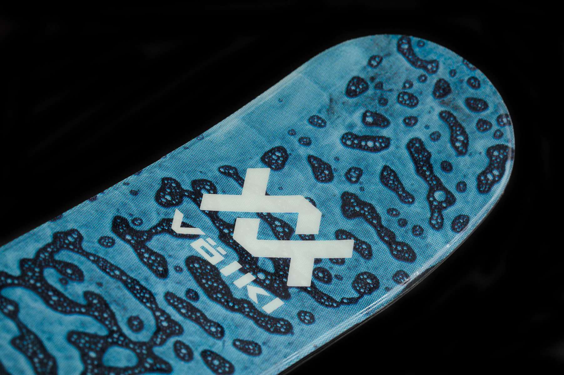 Volk Junior's Revolt 100 Ski 2023 - A blue and white ski with a black pattern of abstract shapes resembling animal prints.