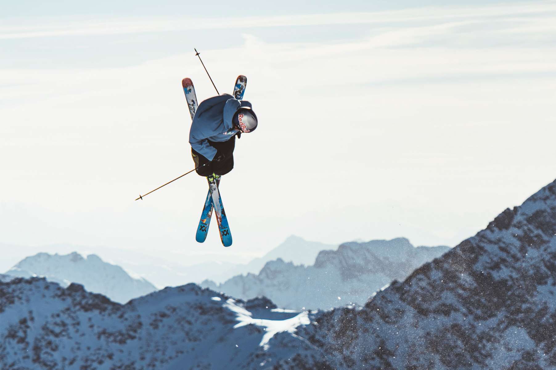 Volkl Revolt 90 Flat Ski 2022-2023 - A pair of blue skis with a white and red patterned design, featuring a distinctive "V" shape at the tip.