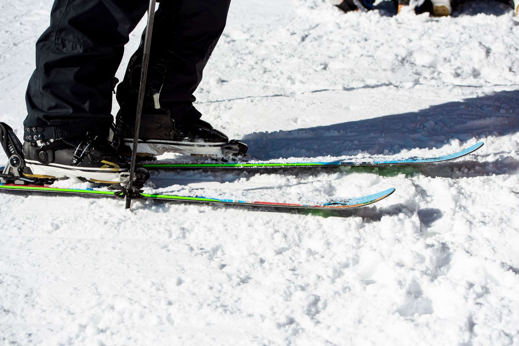 Volkl Revolt 90 Flat Ski 2022-2023 - A pair of skis with a black base and white stripes on the top, featuring a distinctive red stripe near the tip.