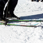 Volkl Revolt 90 Flat Ski 2022-2023 - A pair of skis with a black base and white stripes on the top, featuring a distinctive red stripe near the tip.
