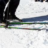 Volkl Revolt 90 Flat Ski 2022-2023 - A pair of skis with a black base and white stripes on the top, featuring a distinctive red stripe near the tip.