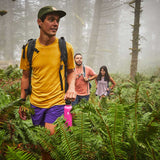 Hydro Flask 40oz Wide Mouth Water Bottle - A pink water bottle with a black lid and white logo, held by a man in a yellow shirt.