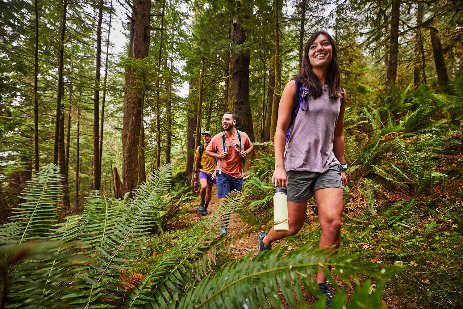Hydro Flask 40oz Wide Mouth Water Bottle - A large water bottle with a wide mouth and black lid, held by a woman in a forest setting.