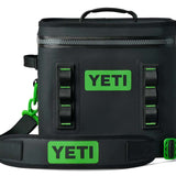 Yeti Hopper Flip 12 Personal Cooler - A black cooler with a zipper closure and two handles on top, featuring a green logo on one side.