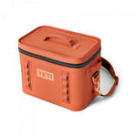 Yeti Hopper Flip 12 Personal Cooler - A coral-colored cooler with a zippered lid and two handles on top, featuring a Yeti logo in white.