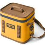 Yeti Hopper Flip 12 Personal Cooler - A yellow cooler with a handle on top and an orange zipper.