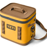 Yeti Hopper Flip 12 Personal Cooler - A yellow cooler with a handle on top and an orange zipper.