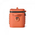 Yeti Hopper Flip 12 Personal Cooler - A coral-colored cooler with a zippered top and handle on one side, featuring a small black logo that reads "YETI" in white letters.