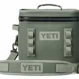 Yeti Hopper Flip 12 Personal Cooler - A dark gray cooler with a zipper closure and two handles on either side, featuring an embossed "YETI" logo in silver on one side.