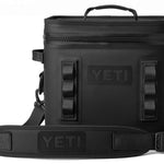 Yeti Hopper Flip 12 Personal Cooler - A black cooler with a zippered top and handle on top, featuring the word "YETI" in white letters on one side.