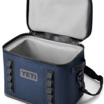 Yeti Hopper Flip 18 Personal Cooler - A navy blue cooler with a zippered lid and two handles on either side, featuring a rectangular shape and a prominent "YETI" logo in white letters on one of the sides.