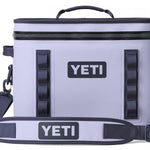 Yeti Hopper Flip 18 Personal Cooler - A light gray cooler with a zippered top and two handles on either side, featuring a dark gray zipper and a small logo in the same color.