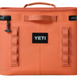 Yeti Hopper Flip 18 Personal Cooler - A coral-colored cooler with a handle on top and an orange zipper pull.