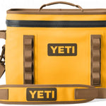 Yeti Hopper Flip 18 Personal Cooler - A yellow cooler with a zipper closure and two handles on top, featuring an orange logo on one side.