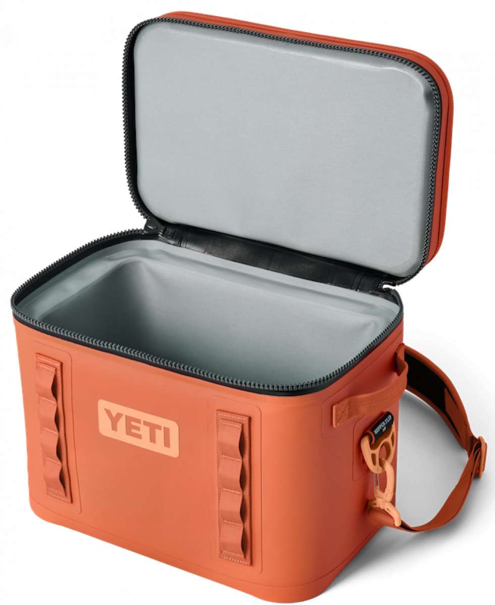 Yeti Hopper Flip 18 Personal Cooler - A red cooler with a handle and zipper closure on top, featuring an orange logo that reads "YETI" in bold letters.