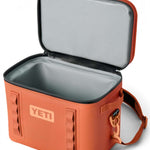 Yeti Hopper Flip 18 Personal Cooler - A red cooler with a handle and zipper closure on top, featuring an orange logo that reads "YETI" in bold letters.