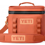 Yeti Hopper Flip 8 Personal Cooler - A coral-colored cooler with a zippered top and two handles, featuring a textured pattern on its surface.