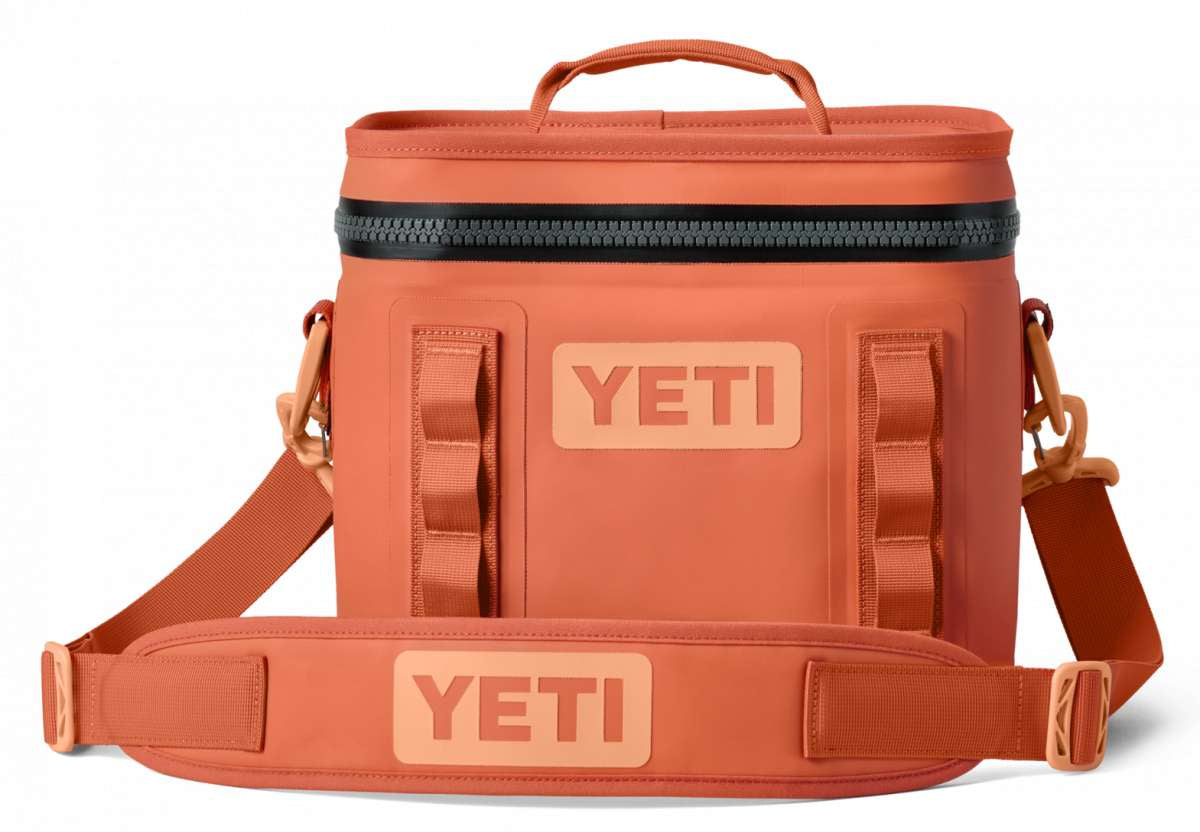 Yeti Hopper Flip 8 Personal Cooler - A coral-colored cooler with a zippered top and two handles, featuring a textured pattern on its surface.