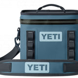 Yeti Hopper Flip 8 Personal Cooler - A blue cooler with a zipper closure and two handles on either side, featuring an "YETI" logo in white letters on one side.
