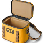 Yeti Hopper Flip 8 Personal Cooler - A yellow cooler with a handle and zipper closure on top, featuring an orange logo on one side.