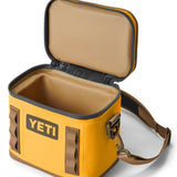 Yeti Hopper Flip 8 Personal Cooler - A yellow cooler with a handle and zipper closure on top, featuring an orange logo on one side.
