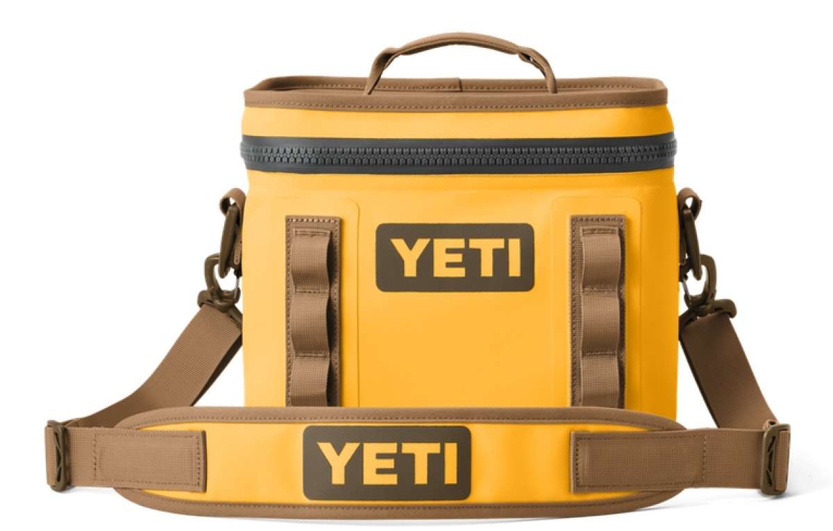 Yeti Hopper Flip 8 Personal Cooler - A yellow cooler with a handle on top and two adjustable shoulder straps attached to the sides.