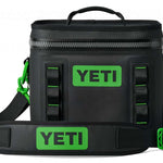 Yeti Hopper Flip 8 Personal Cooler - A black cooler with a zipper closure and green accents on the handle and carabiner clip.