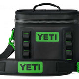 Yeti Hopper Flip 8 Personal Cooler - A black cooler with a zipper closure and green accents on the handle and carabiner clip.