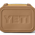 Yeti Hopper Flip 8 Personal Cooler - A tan cooler with a zippered lid and two handles on either side, featuring a prominent "YETI" logo embossed in the center of the front panel.