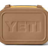Yeti Hopper Flip 8 Personal Cooler - A tan cooler with a zippered lid and two handles on either side, featuring a prominent "YETI" logo embossed in the center of the front panel.