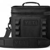 Yeti Hopper Flip 8 Personal Cooler - A black cooler with a zippered top and handle on top, featuring an embossed "YETI" logo on one side.