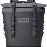 Yeti Hopper M12 Backpack Soft Cooler - A large, dark gray backpack-style cooler with a zippered main compartment and two side pockets.