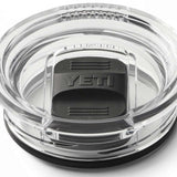 Yeti Rambler 20 oz. Travel Mug - A clear plastic travel mug with a black lid and embossed "YETI" logo on top.