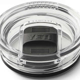 Yeti Rambler 20 oz. Travel Mug - A clear plastic travel mug with a black lid and embossed "YETI" logo on top.