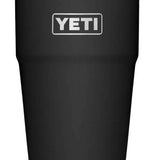 Yeti Rambler 26 oz. Straw Cup - A dark-colored tumbler with a clear plastic straw and lid, featuring the word "YETI" in white letters on one side.