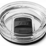 Yeti Rambler 30 oz. Travel Mug - A clear plastic travel mug with a black lid and handle, featuring the embossed word "YETI" on the side.