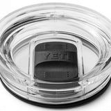 Yeti Rambler 30 oz. Travel Mug - A clear plastic travel mug with a black lid and handle, featuring a textured pattern on the body.