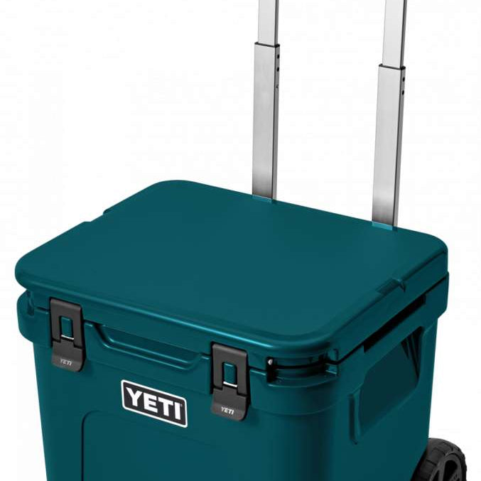 Yeti Roadie 48 Wheeled Cooler - A compact, wheeled cooler with a dark gray lid and handle, featuring a small white logo on the front that reads "YETI" in bold letters.