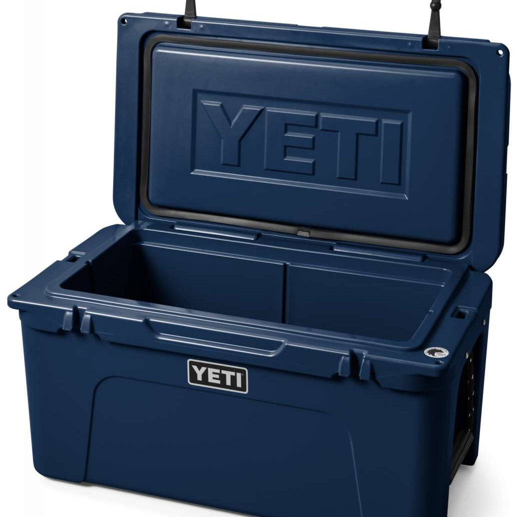 Yeti Tundra 65 Cooler - A large, rectangular cooler with a dark gray lid and matching body, featuring a prominent "YETI" logo on the front in white lettering.