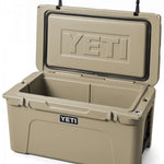 Yeti Tundra 65 Cooler - A tan cooler with a black handle on top, featuring the word "YETI" embossed in silver letters on one side.