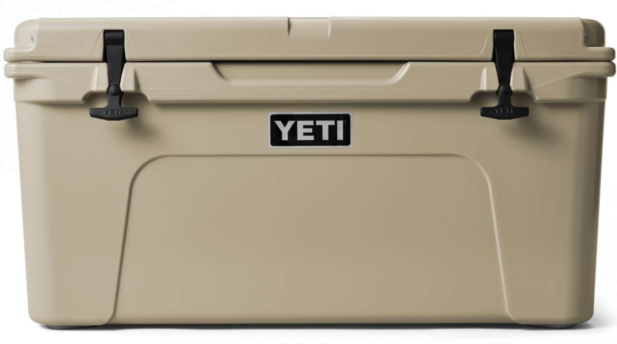 Yeti Tundra 65 Cooler - A large, tan cooler with a black handle on top and two latches on either side of it.