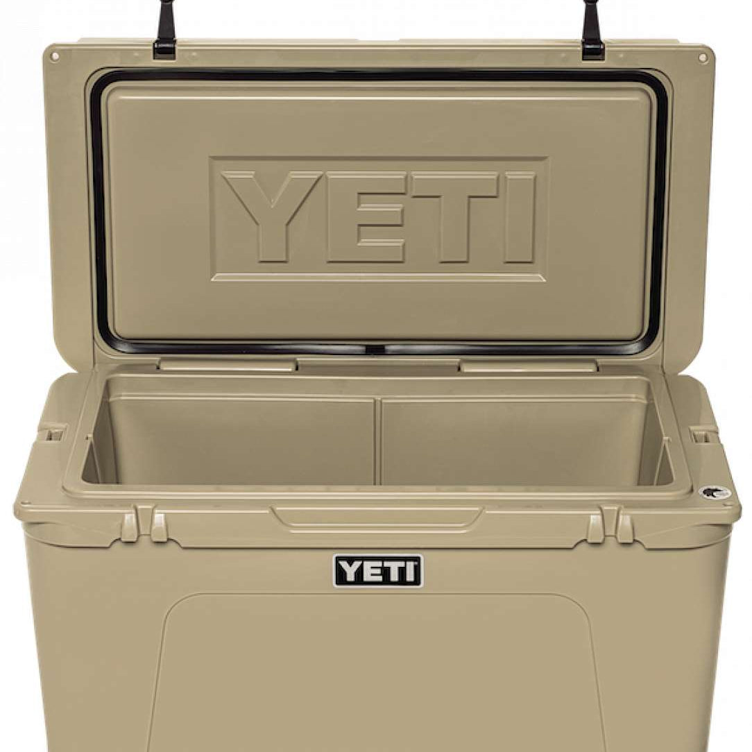 Yeti Tundra 75 Cooler - A large, tan cooler with a black handle on top and two latches on either side of the lid.
